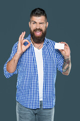 cheerful bearded man showing blank debit card with copy space