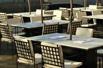 Outdoor cafe tables on a cool morning