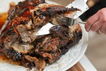 someone is putting a fork on a meat covered plate of food