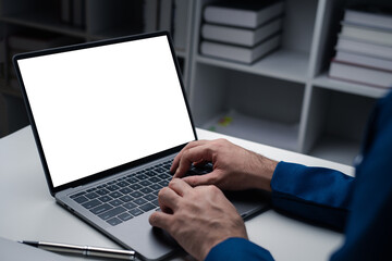 Close up view of businessman using laptop computer at office desk in the office room.