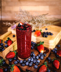 Healthy vitamin. Summer berries smoothie in mason jar on rustic wooden table