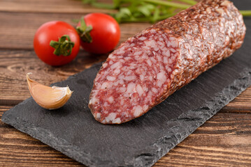 Salami sausage cut with tomato and garlic