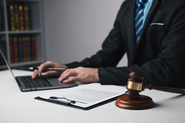 Fototapeta premium Close up view of lawyer working on his laptop computer, working for his client in the office room.