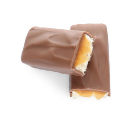 Pieces of chocolate bar with caramel on white background, top view