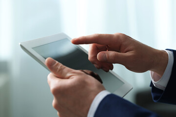 Closeup view of man using new tablet indoors