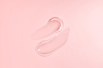 Liquid gel smear isolated on beige background. Beauty cosmetic smudge such as pure transparent aloe lotion, facial jelly serum, cleanser, shower gel or shampoo top view.