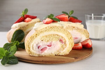 Fototapeta na wymiar Delicious cake roll with strawberries and cream on wooden board, closeup