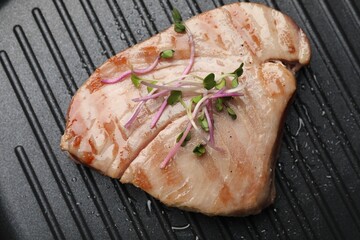 Delicious tuna steak with microgreens in grill pan, top view