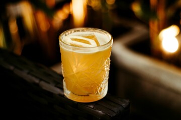Refreshing can of yellow cocktail positioned on a dark background