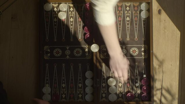 playing backgammon, top shot of backgammon board, 4k footage, play at eye level.