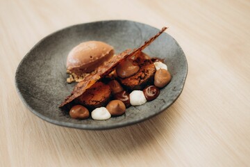 some kind of dessert on a black plate on a wood table