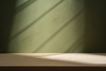 Empty table on khaki green texture wall background. Composition with window shadows on the wall and...