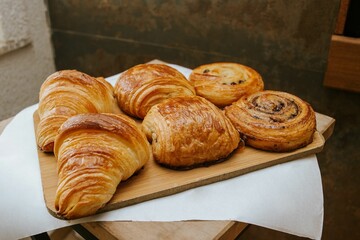 several fresh croissants on a platter at a bakery