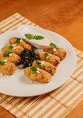 Closeup shot of a plate containing Arancini, an Italian fried rice ball