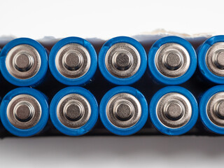 Alkaline batteries on a light background. The concept of energy sources and their use. Lots of AA batteries.