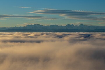 A mountain top peeking through a white fluffy cloud, Solothurn, Wisen municipality of Switzerland