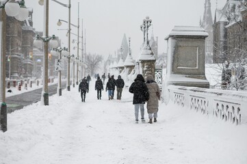 People walking outdoors during a cold snowy day in Ottawa, Canada