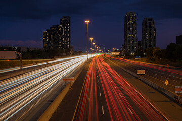 Fototapeta na wymiar Speed traffic, light trails on freeway at night, long exposure abstract urban background. Toronto West highway 427 southbound. High travel speed effect, dui, careless, dangerous, drunk driving concept