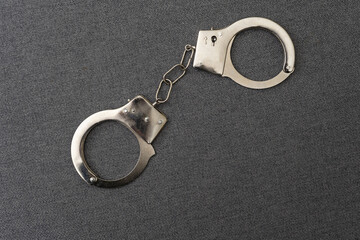 Police handcuffs on the USA flag, close-up