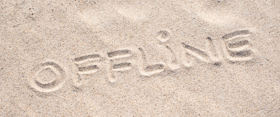 Sand background. Word Offline written on sand. Sandy beach. Blank negative space for copy. Summer holiday banner.