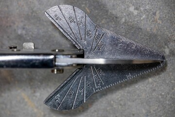 Closeup shot of a skirting boards pliers with shallow depth of field on a concrete floor