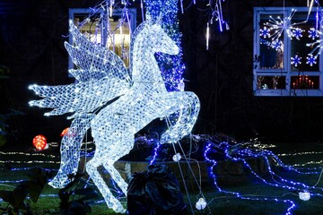A glowing white Pegasus among Christmas decorations