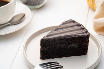 Delicious Sliced of Classic Chocolate Cake on white plate