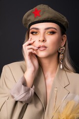 Caucasian woman wearing military hat with red star badge