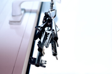 A bunch of keys hanging from a doorknob.