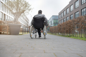 Obraz premium a physically disabled person on a wheelchair at a walk.