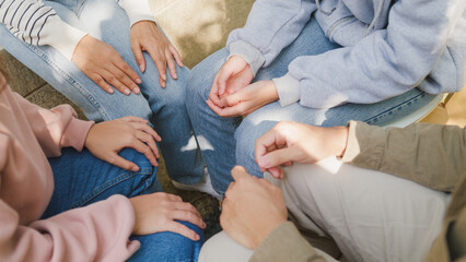 Close-up hands of diverse multiracial male and female group sit circle explain tell story sharing...