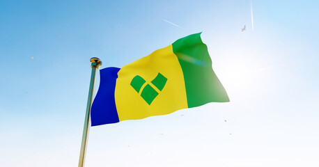 Flag of Saint Vincent waving in the wind, sky and sun background. St Vincent and the Grenadines flag. 3D rendering realistic waving flag background. 