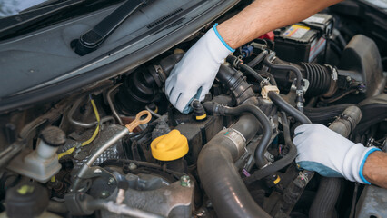 Young man checking and maintenance on his car. Car repair and maintenanc concept.