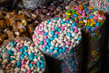 Fototapeta na wymiar Bags of sweets, pile of coated almonds