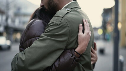 Fototapeta premium Young couple embrace in city street. Loving compassionate relationship. Male partner having sympathy. Two people support and help