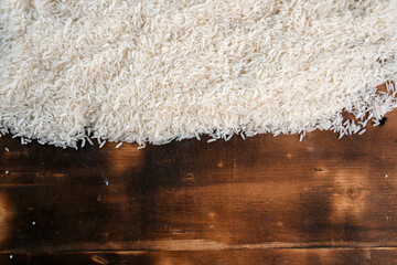 white rice natural long rice grain on wooden table use texture background