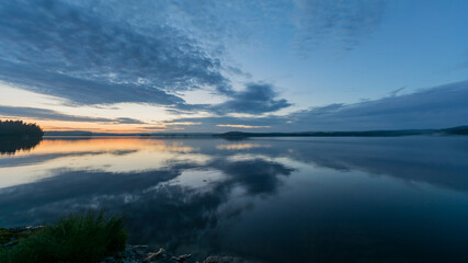 Summer lake scenery with clouds reflected on the water in Finland
