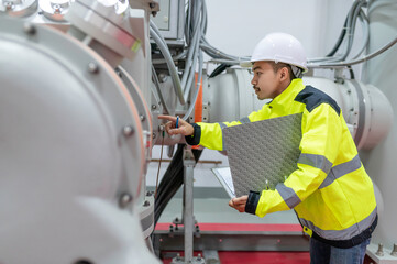 Electrical engineer man checking voltage at the Power Distribution Cabinet in the control...