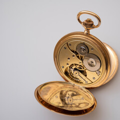 vintage gold pocket watch longines isolated on white background