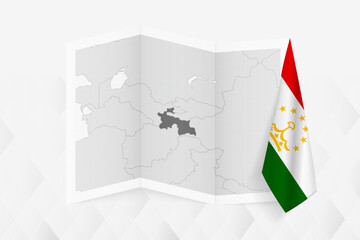 A grayscale map of Tajikistan with a hanging Tajikistani flag on one side. Vector map for many types of news.