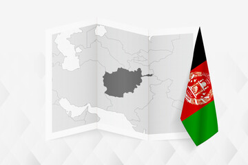 A grayscale map of Afghanistan with a hanging Afghan flag on one side. Vector map for many types of news.