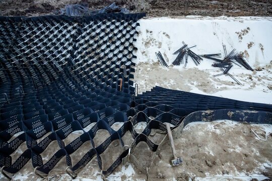 HDPE Geocell Ground Grid Paver and Geotextile. Plastic Geocell For Construction and nails closeup photo