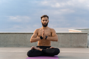 Fototapeta na wymiar attractive hansome man with athletic strong body doing morning yoga dzen meditation