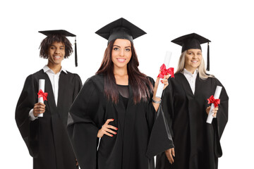 Group of male and female graduate students in gowns holding diplomas