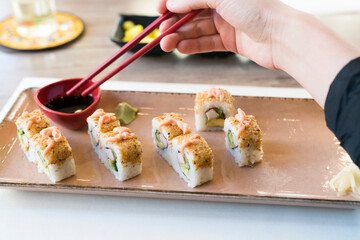 Sushi Restaurant. woman eating sushi at Japanese restaurant