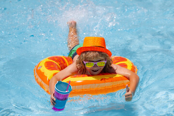 Cute kids face. Child splashing in swimming pool. Swim water sport activity on summer vacation with child. Kids water toys.