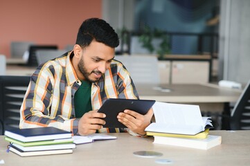Obraz premium Happy indian male student at the university