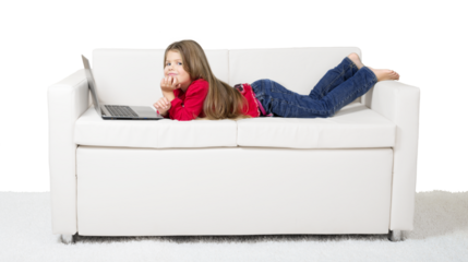 Cute little girl using laptop on sofa isolated on white background
