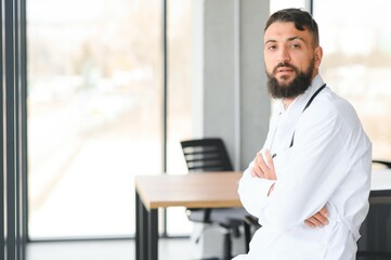 Portrait of a young arabian doctor standing in the the clinic