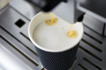 Preparing coffee with milk in coffee machine